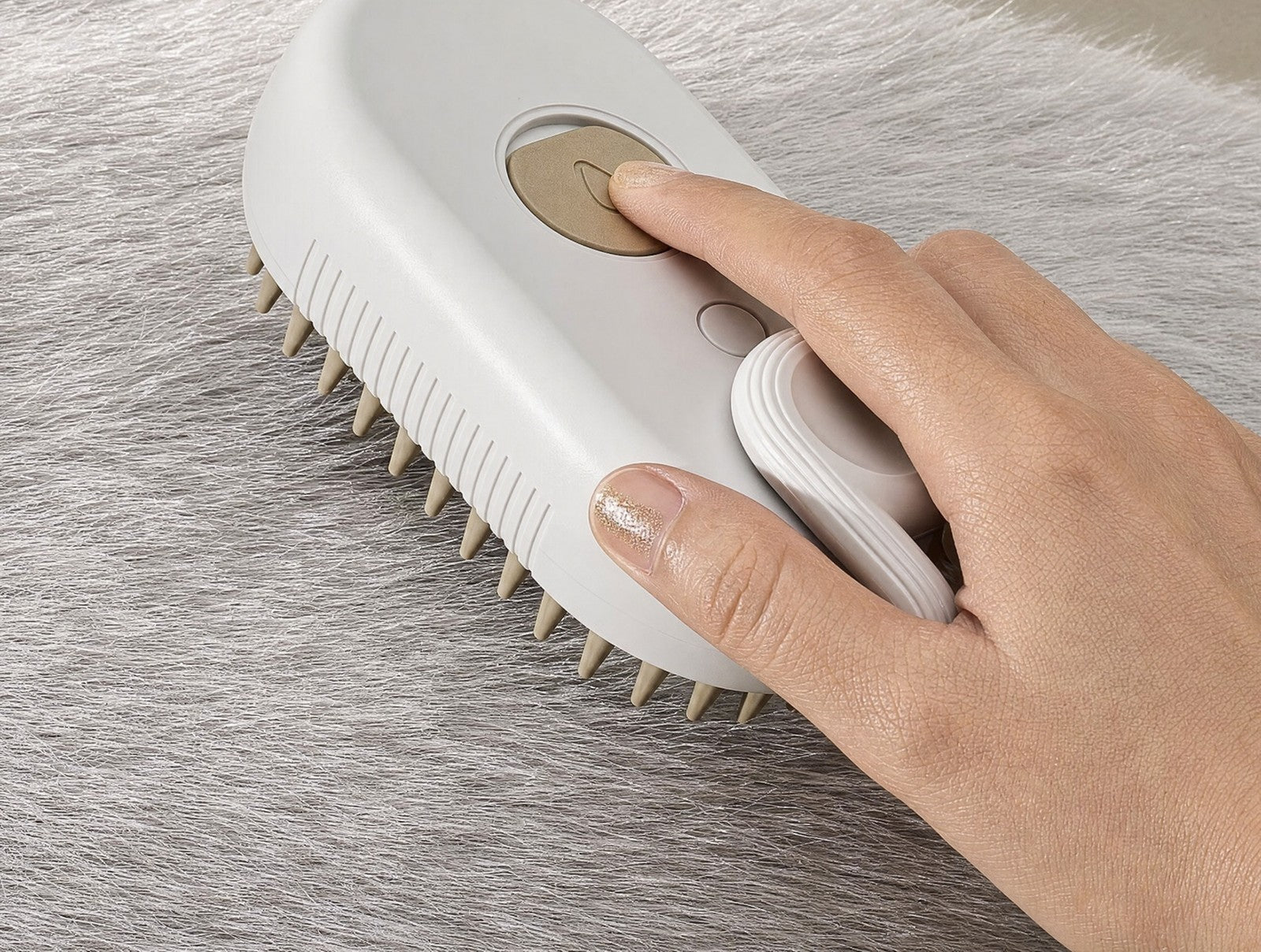 Hand using the Glowcoat brush to groom a pet's coat