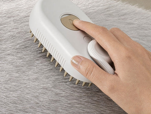 Hand using the Glowcoat brush to groom a pet's coat